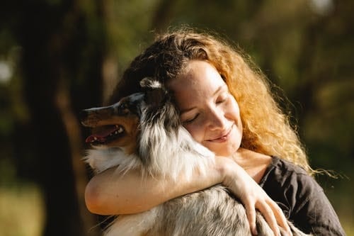 woman hugging her dog
