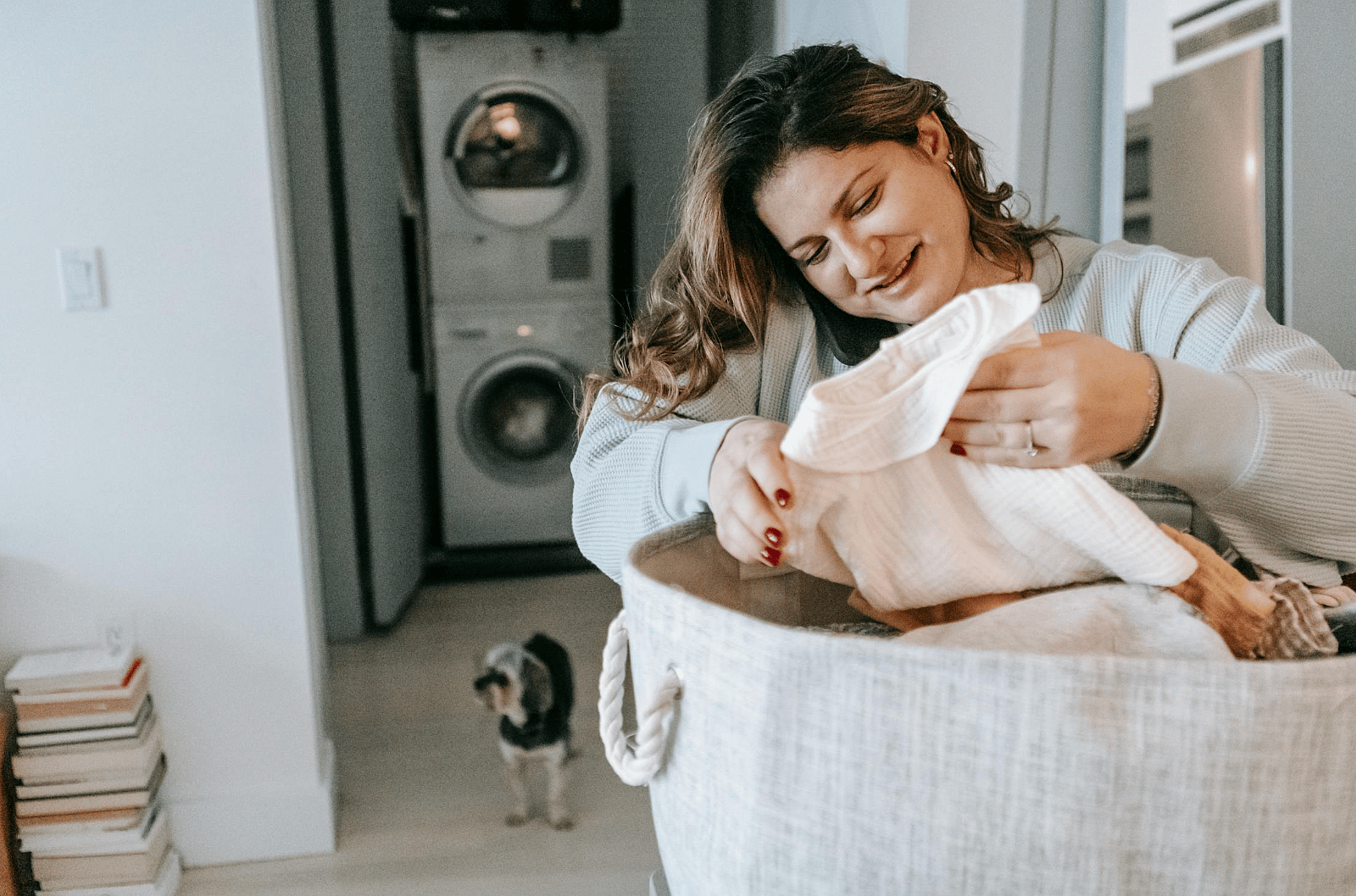 Clean for your dog. A woman doing laundry for her dog