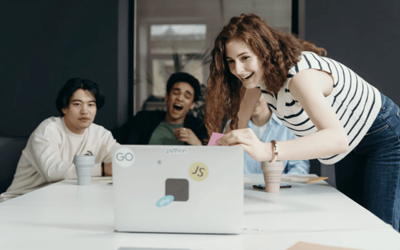 people laugh at a video in office