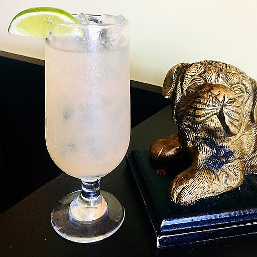 Signature cocktail and beautiful dog sculpture at the Fat Dog