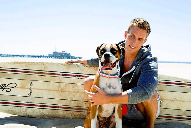 Flip and Rocky in front of surfboard