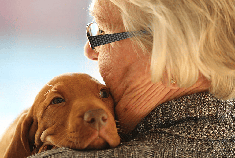 elderly woman with puppy