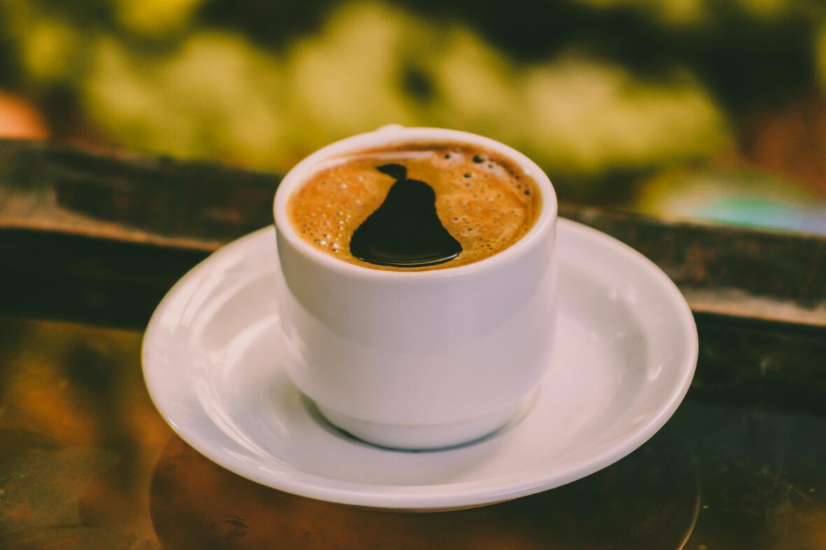 Close-up of black coffee in a white ceramic cup, caffeine-loaded beverages are among the human foods toxic to dogs 